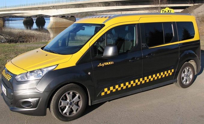 Official City Taxi with a tax meter.